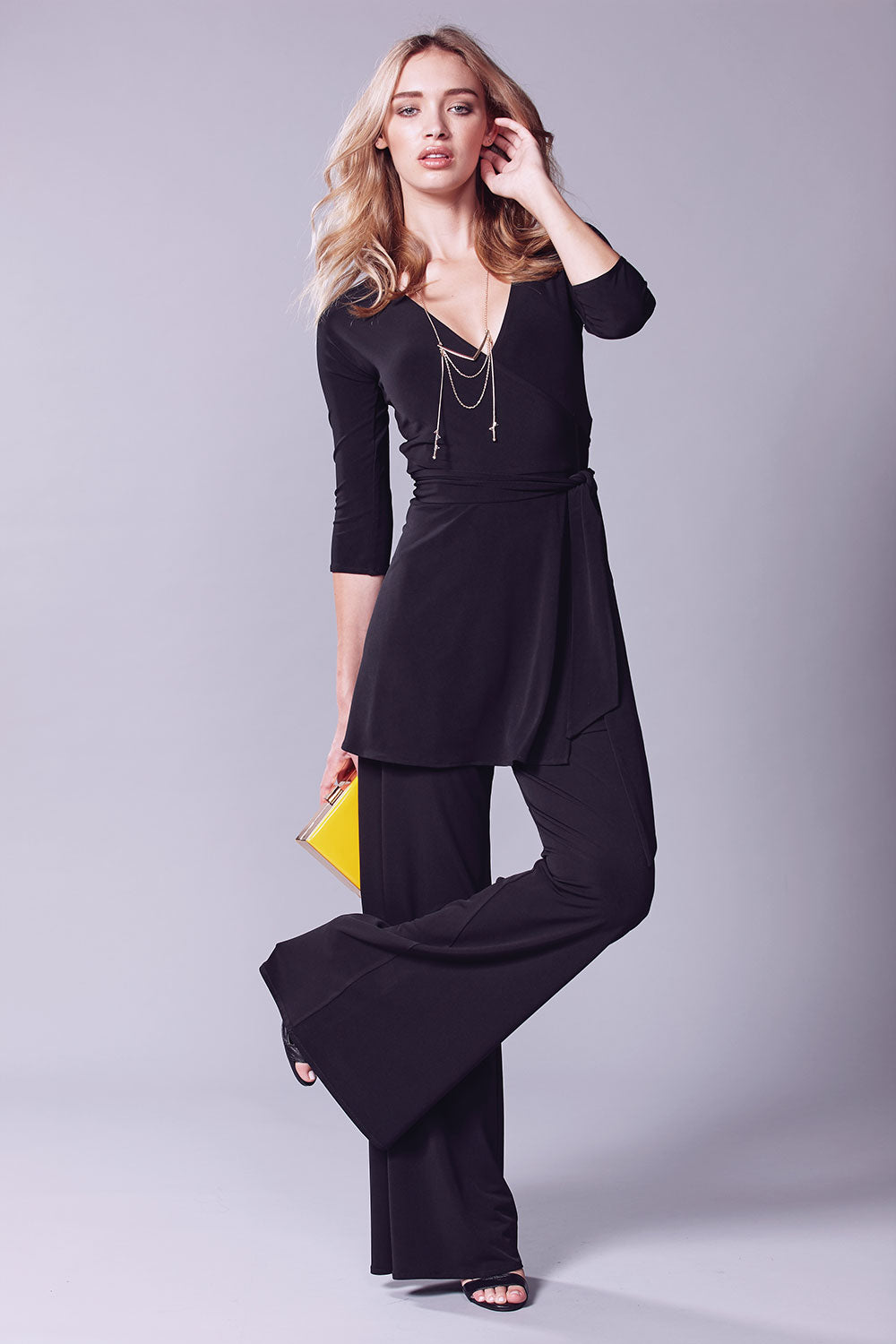 A model wearing the Turn around Tunic in colour Black (Black), from the front, showing the whole outfit