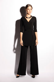 A model wearing the Turn around Tunic in colour Black (Black), from the front, showing the whole outfit