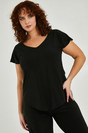 Model Maddy wearing size 16 of the Analia Reversible Top in colour Black (Black), from the front, cropped image