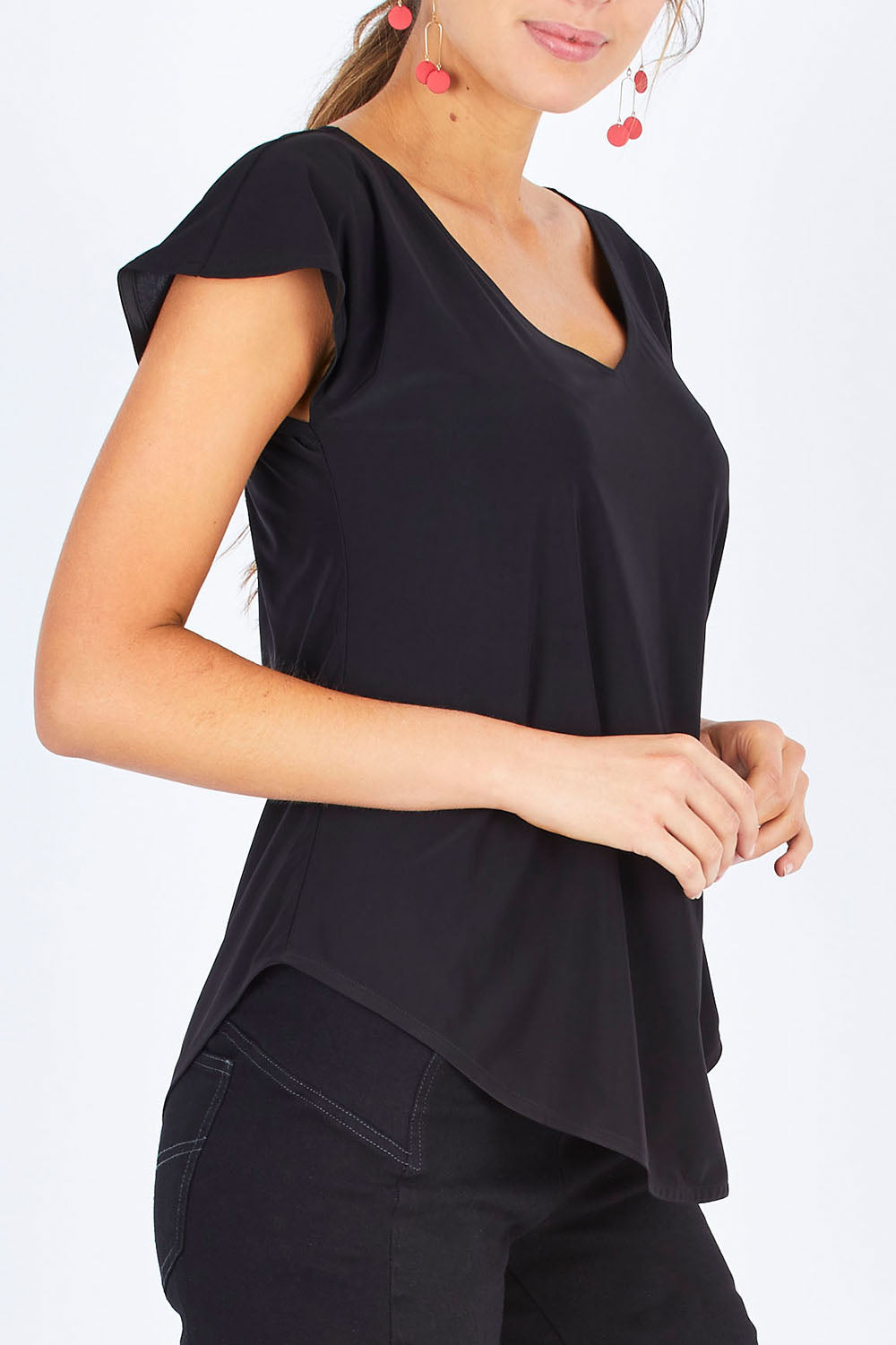 Model Madeline wearing size 10 of the Analia Reversible Top in colour Black (Black), from the front, cropped image