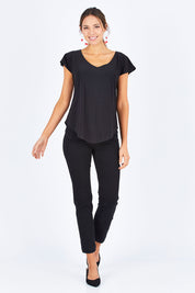 Model Madeline wearing size 10 of the Analia Reversible Top in colour Black (Black), from the front, showing the whole outfit