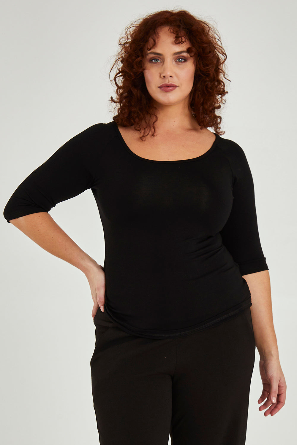 Model Maddy wearing size 16 of the 3/4 Sleeve Top in colour Black (Black), from the front, cropped image