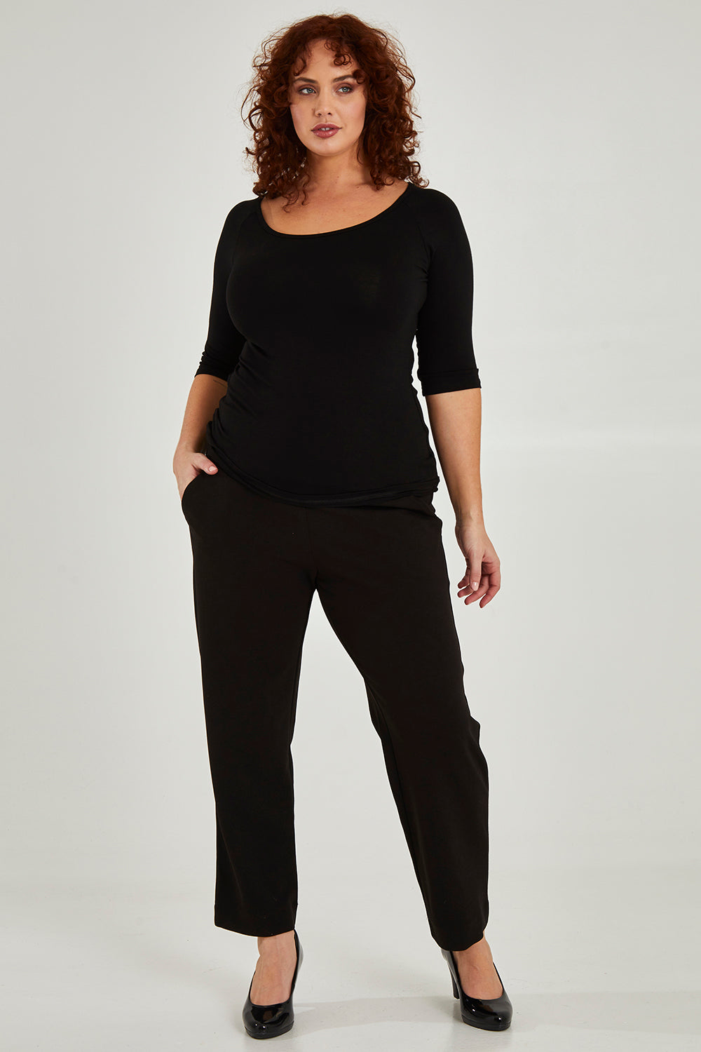 Model Maddy wearing size 16 of the 3/4 Sleeve Top in colour Black (Black), from the front, showing the whole outfit