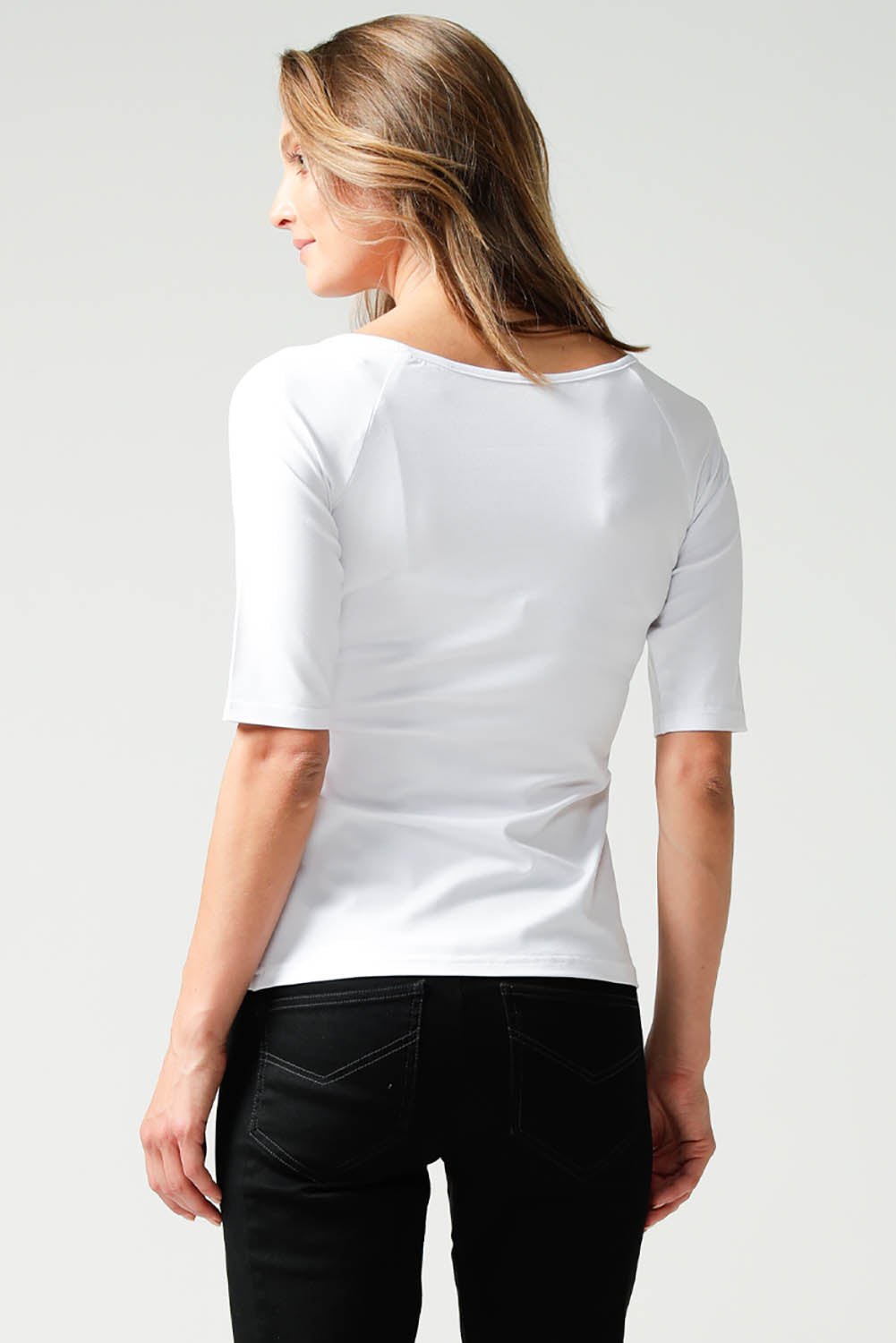 A model wearing the 3/4 Sleeve Top in colour White (White), from the back