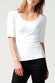 A model wearing the 3/4 Sleeve Top in colour White (White), from the front, cropped image