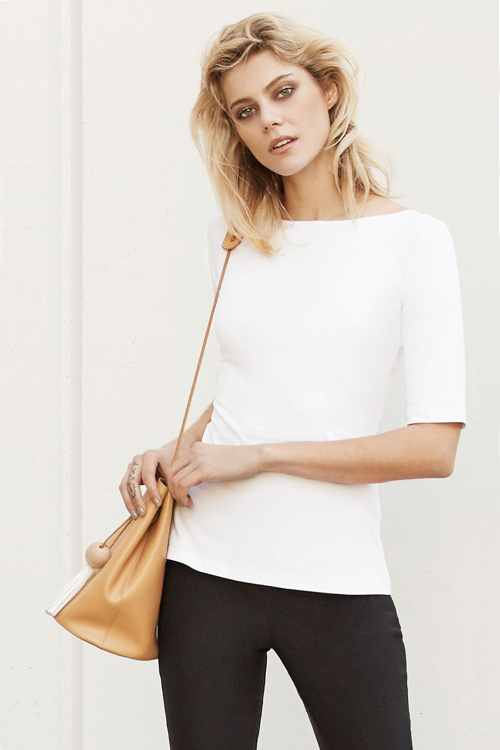 A model wearing the 3/4 Sleeve Top in colour White (White), from the front, showing the whole outfit