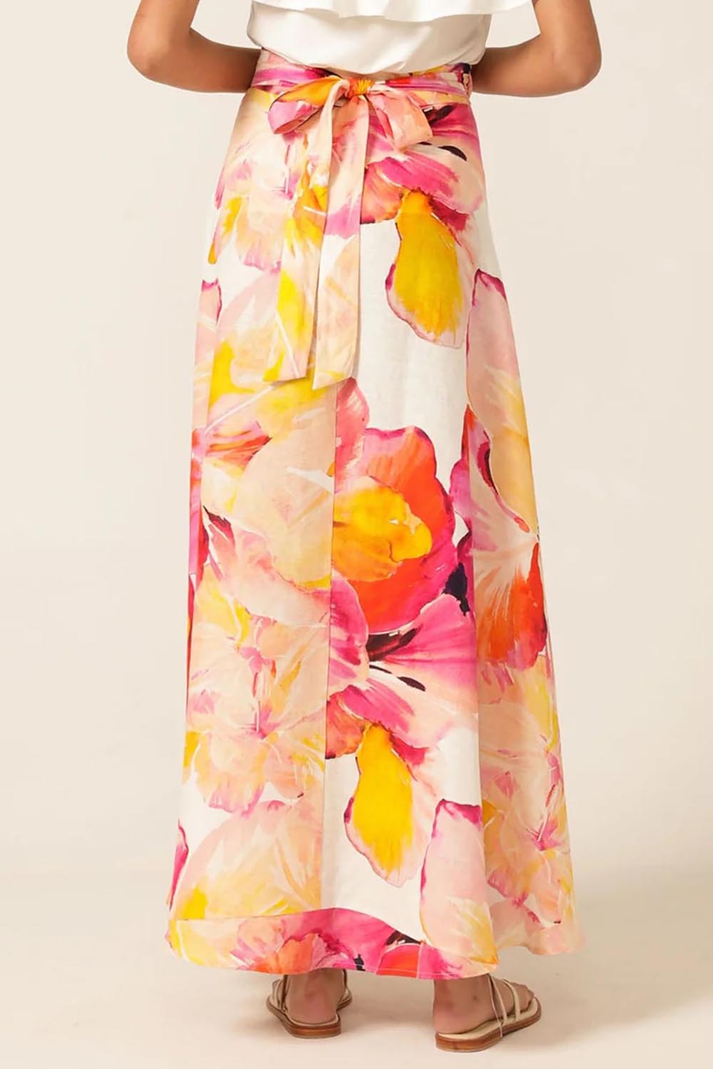 A model wearing the Sunspritz Linen Wrap Skirt in colour Hibiscus (Pink), from the back