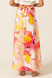A model wearing the Sunspritz Linen Wrap Skirt in colour Hibiscus (Pink), from the back