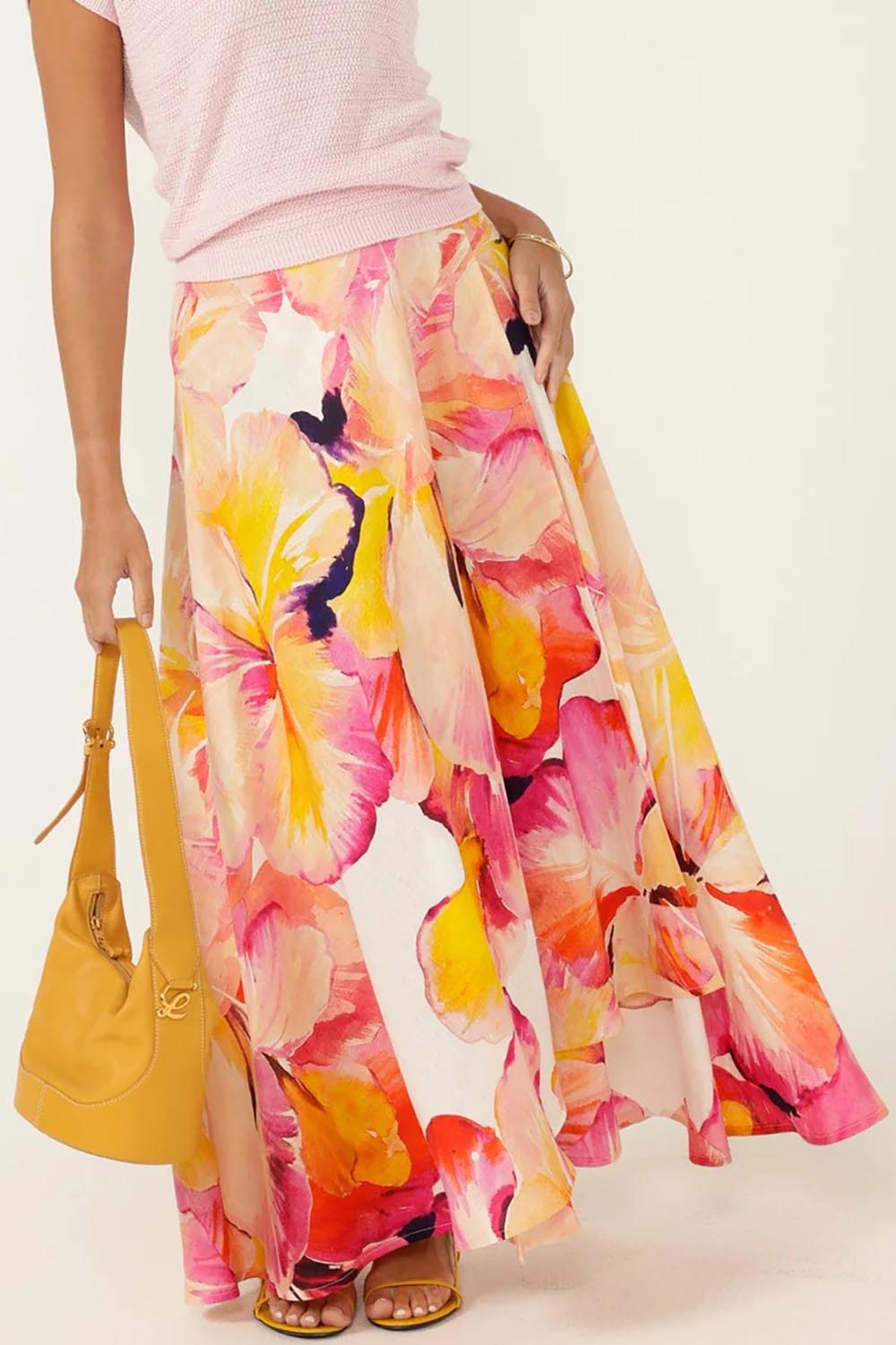 A model wearing the Sunspritz Linen Wrap Skirt in colour Hibiscus (Pink), from the front, cropped image