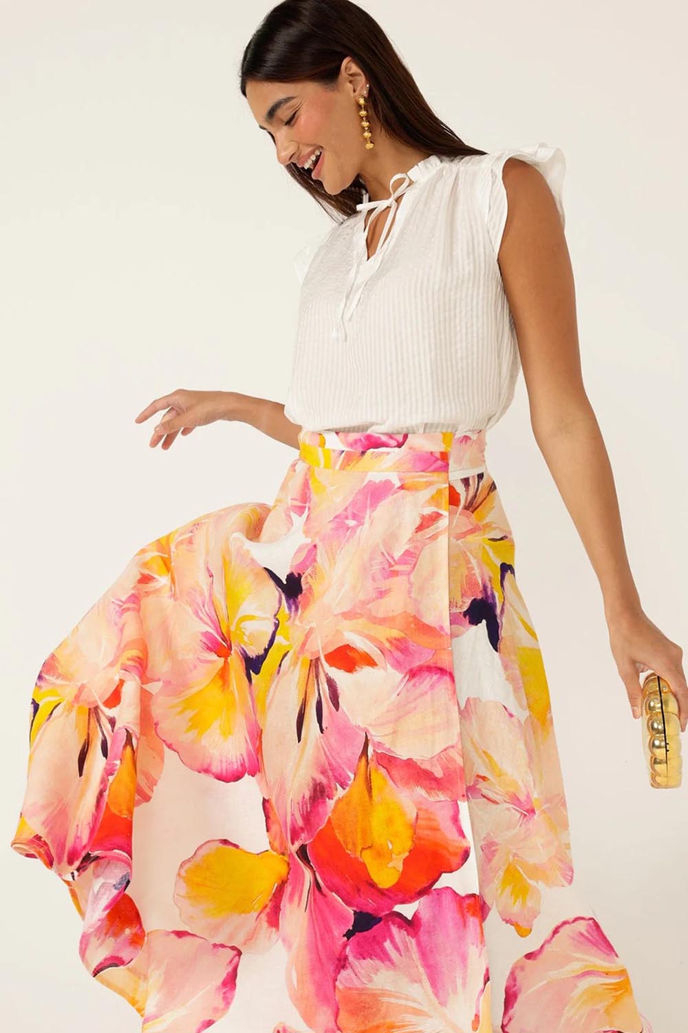 A model wearing the Sunspritz Linen Wrap Skirt in colour Hibiscus (Pink), from the front, cropped image