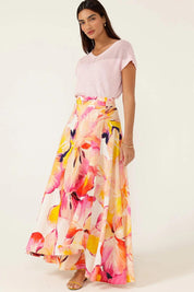 A model wearing the Sunspritz Linen Wrap Skirt in colour Hibiscus (Pink), from the front, showing the whole outfit