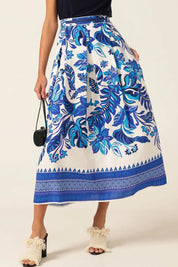 A model wearing the Yacht Party Skirt in colour Messina (Blue), from the front, cropped image