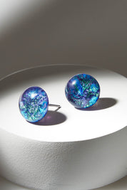 A model wearing size OneSize of the Medium Glass Stud Earrings in colour Marine (Blue), from the front, showing the whole outfit