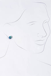 A model wearing size OneSize of the Medium Glass Stud Earrings in colour Marine (Blue), from the front, showing the whole outfit