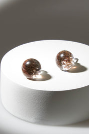 A model wearing size OneSize of the Small Glass Stud Earrings in colour Bronze (Metallics), from the front, showing the whole outfit