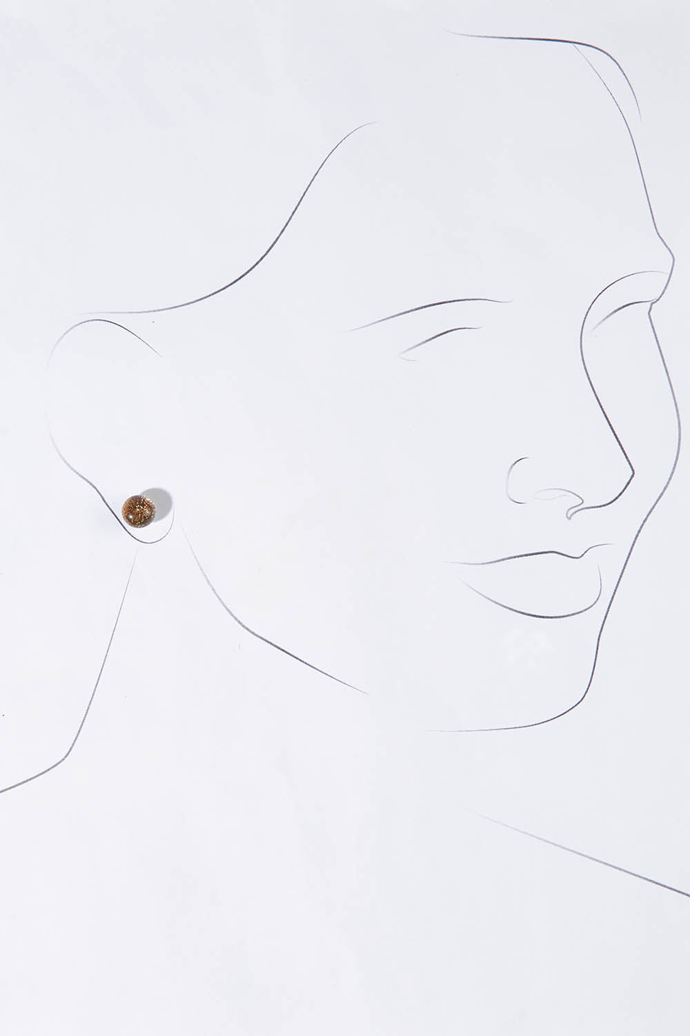 A model wearing size OneSize of the Small Glass Stud Earrings in colour Bronze (Metallics), from the front, showing the whole outfit