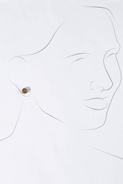 A model wearing size OneSize of the Small Glass Stud Earrings in colour Bronze (Metallics), from the front, showing the whole outfit
