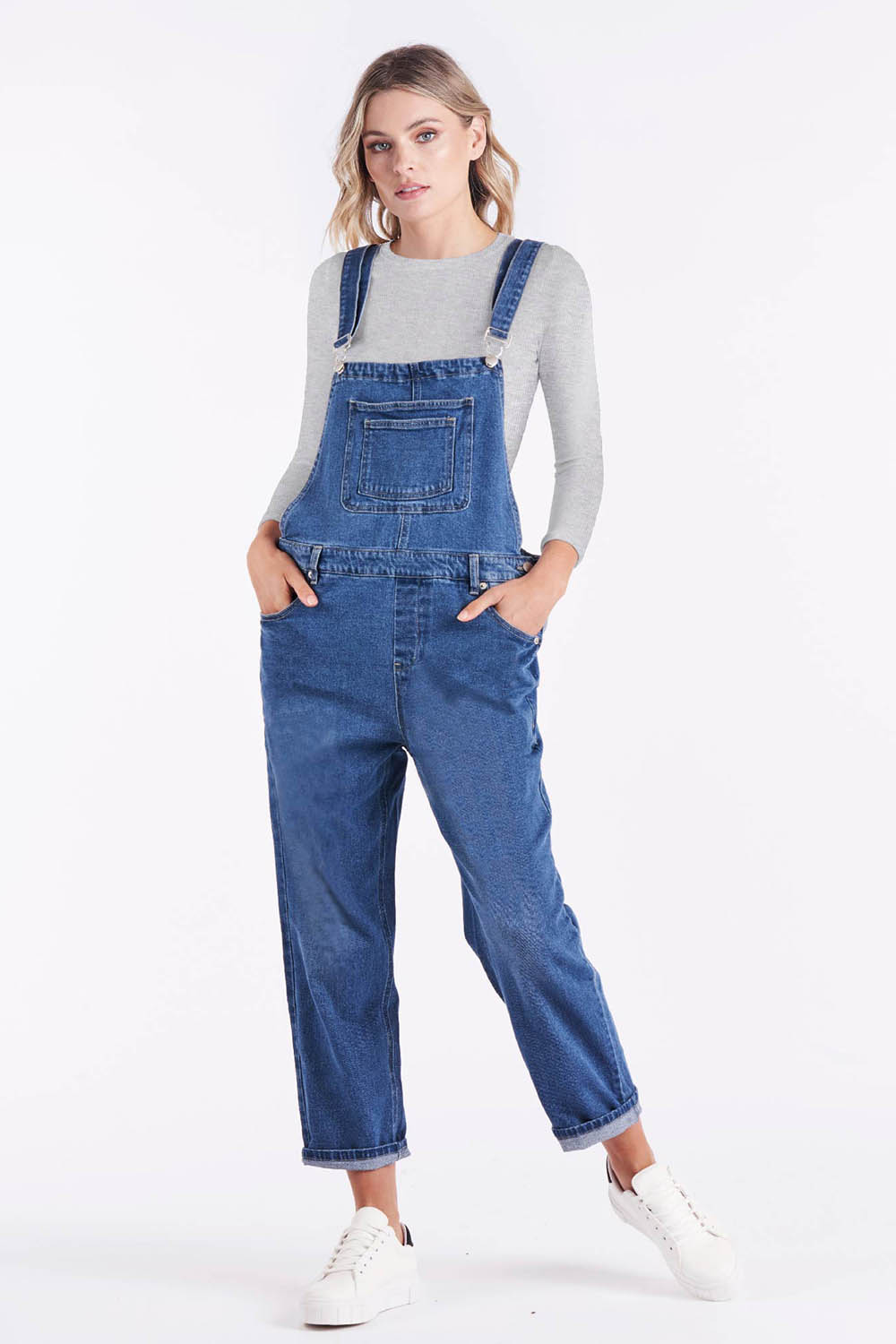 A model wearing the Simone Dungaree in colour Wornwash (Blue), from the front, showing the whole outfit