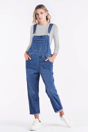 A model wearing the Simone Dungaree in colour Wornwash (Blue), from the front, showing the whole outfit