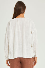 Model Elhana wearing size 10 of the Cerise Top in colour White (White), from the back