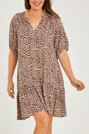 Model Georgia wearing size 10 of the Camilla Dress in colour Animal (Black), from the front, cropped image
