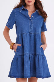 Model Madeline wearing size 10 of the Kellie Denim Dress in colour 80Wash (Blue), from the front, cropped image