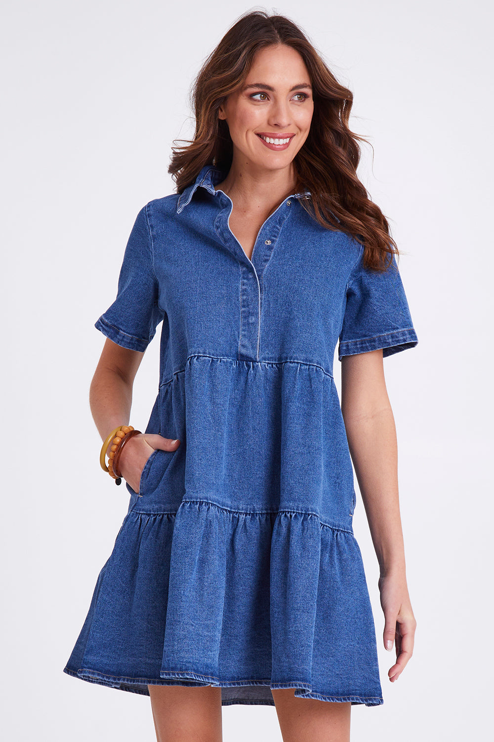 Model Madeline wearing size 10 of the Kellie Denim Dress in colour 80Wash (Blue), from the front, cropped image