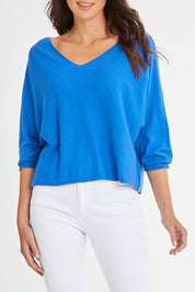 Model Madeline wearing size 10 of the Donna Knit Top in colour Cobalt (Blue), from the front, cropped image