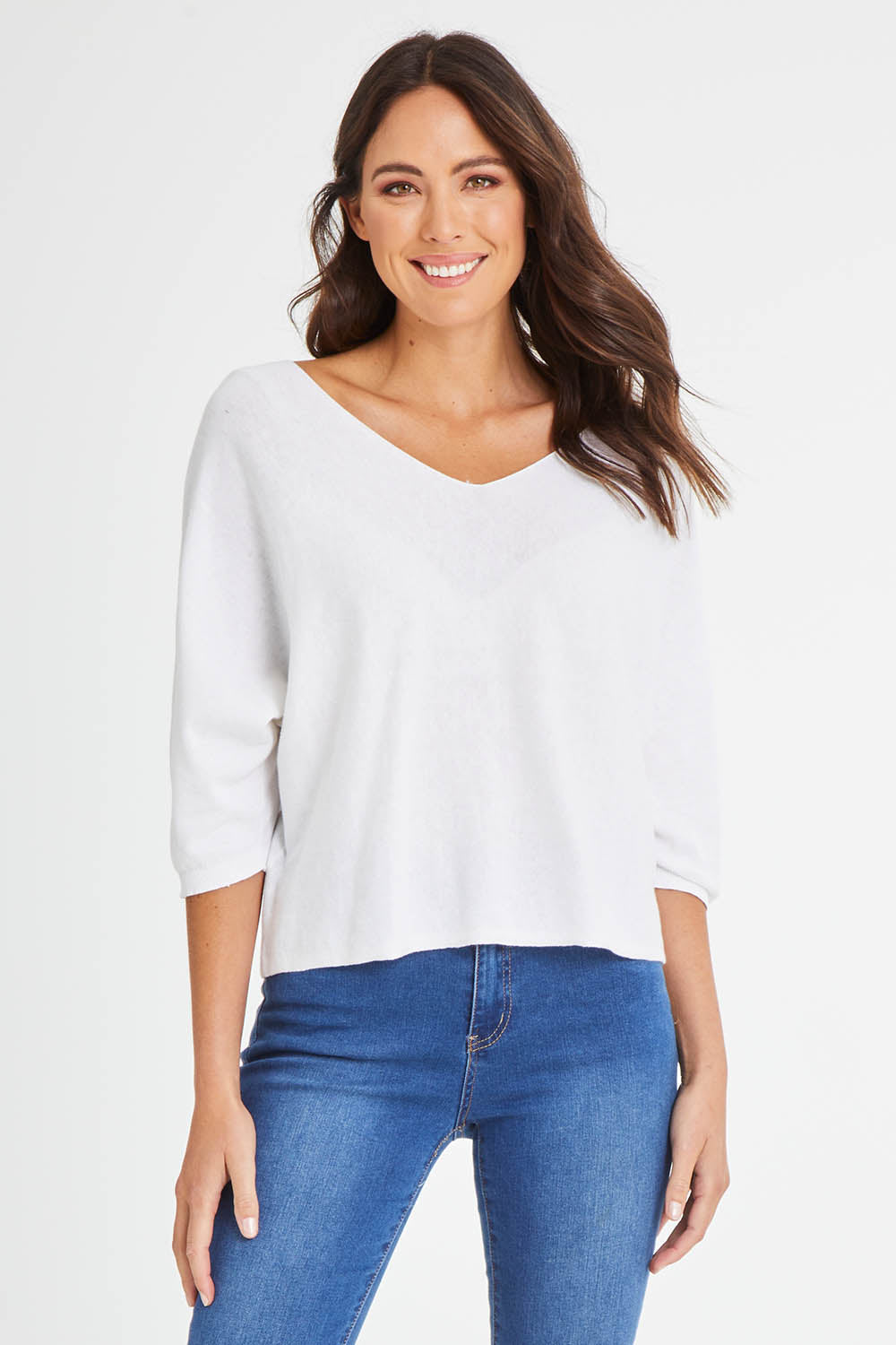 Model Madeline wearing size 10 of the Donna Knit Top in colour White (White), from the front, cropped image