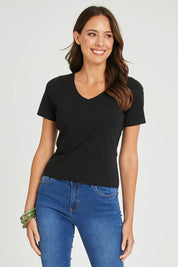 Model Madeline wearing size 10 of the Claire V Neck Tee in colour Black (Black), from the front, cropped image