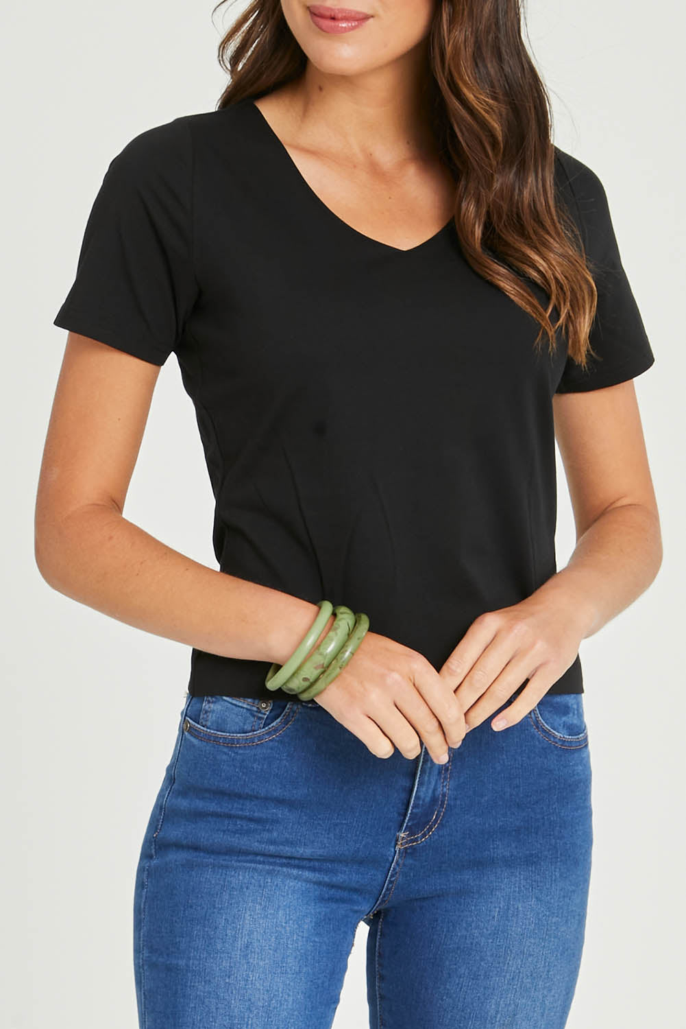 Model Madeline wearing size 10 of the Claire V Neck Tee in colour Black (Black), from the front, cropped image