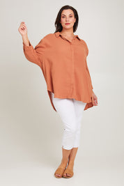 Model Poppy wearing size 14 of the Felix Oversized Shirt in colour Mocha, from the front, showing the whole outfit