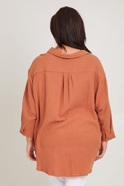 Model Poppy wearing size 16 of the Felix Oversized Shirt in colour Mocha, from the back