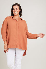 Model Poppy wearing size 16 of the Felix Oversized Shirt in colour Mocha, from the front, cropped image