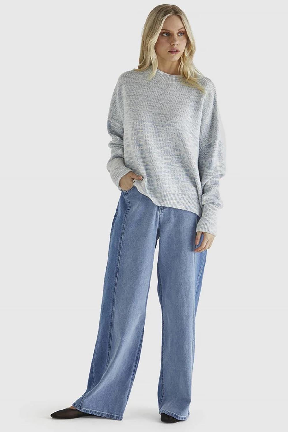 A model wearing the Kirsha Jumper in colour Bluemarle (Blue), from the front, showing the whole outfit