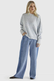 A model wearing the Kirsha Jumper in colour Bluemarle (Blue), from the front, showing the whole outfit