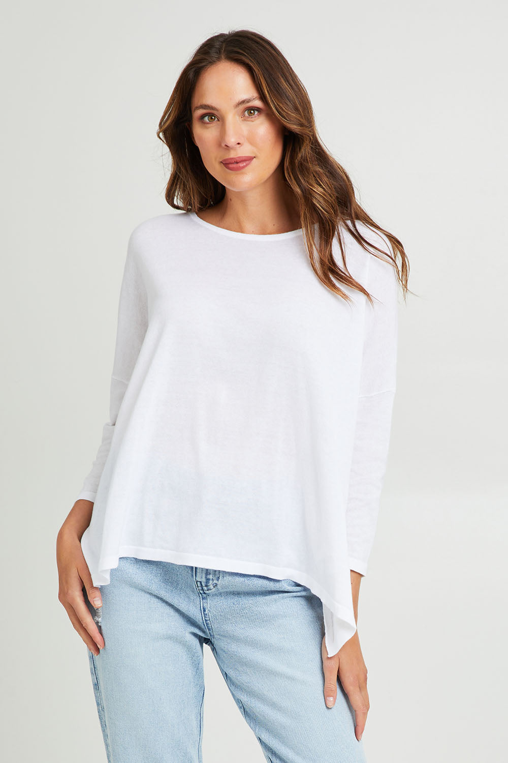 Model Madeline wearing size 10 of the Shiv Dolmain Knit in colour White (White), from the front, cropped image
