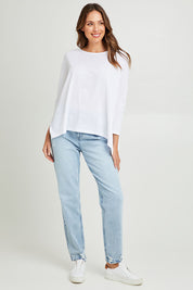 Model Madeline wearing size 10 of the Shiv Dolmain Knit in colour White (White), from the front, showing the whole outfit