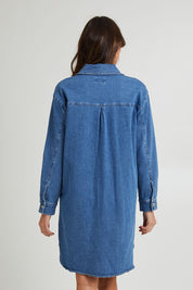 Model Madeline wearing size 10 of the Nya Long Denim Shacket Dress in colour 80Wash (Blue), from the back