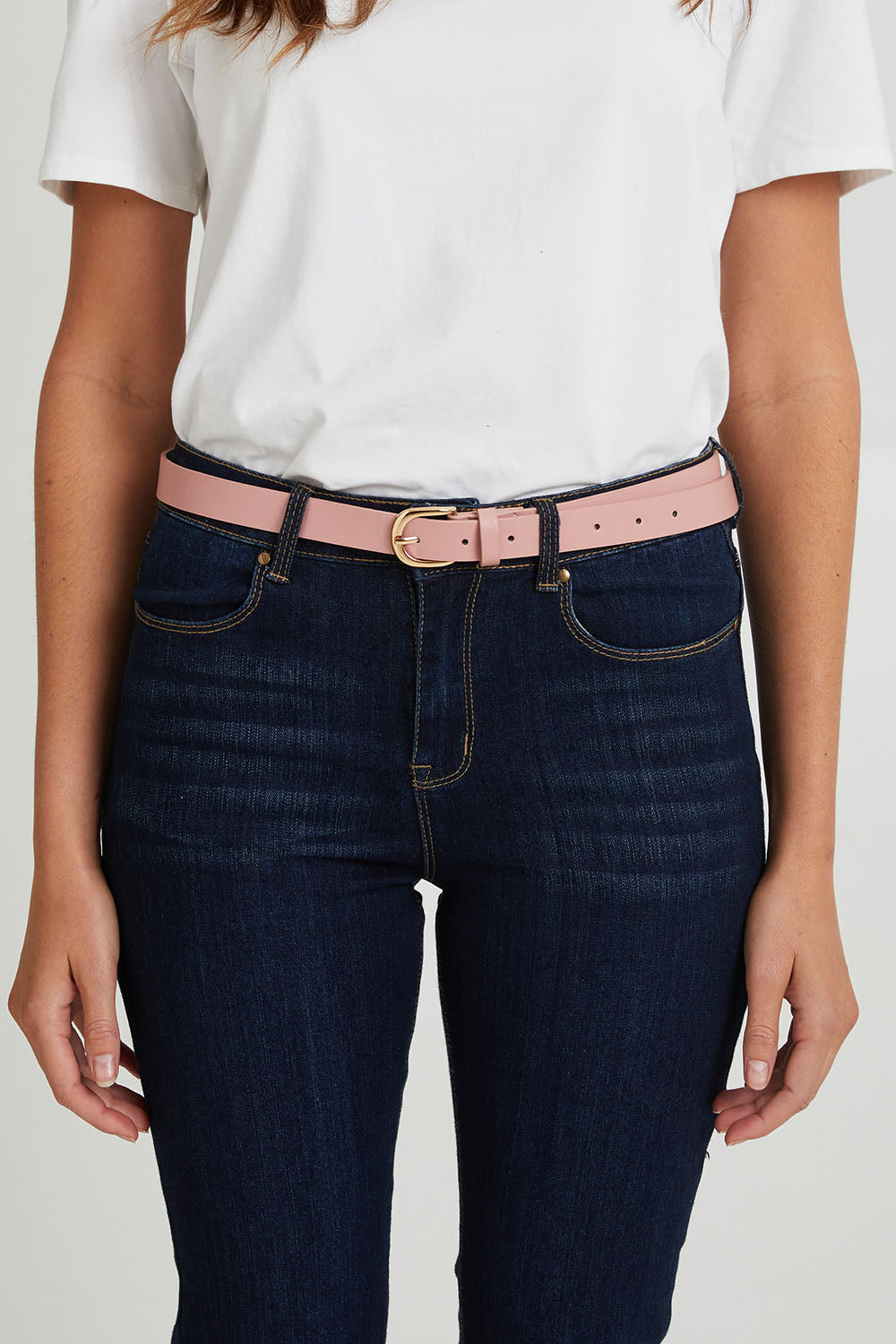 Model Madeline wearing the Seema Belt 3 Pack in colour Blushblue (Pink), from the front, cropped image