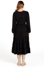 A model wearing the Charity Tiered Midi Dress in colour Black (Black), from the back