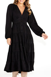 A model wearing the Charity Tiered Midi Dress in colour Black (Black), from the front, cropped image