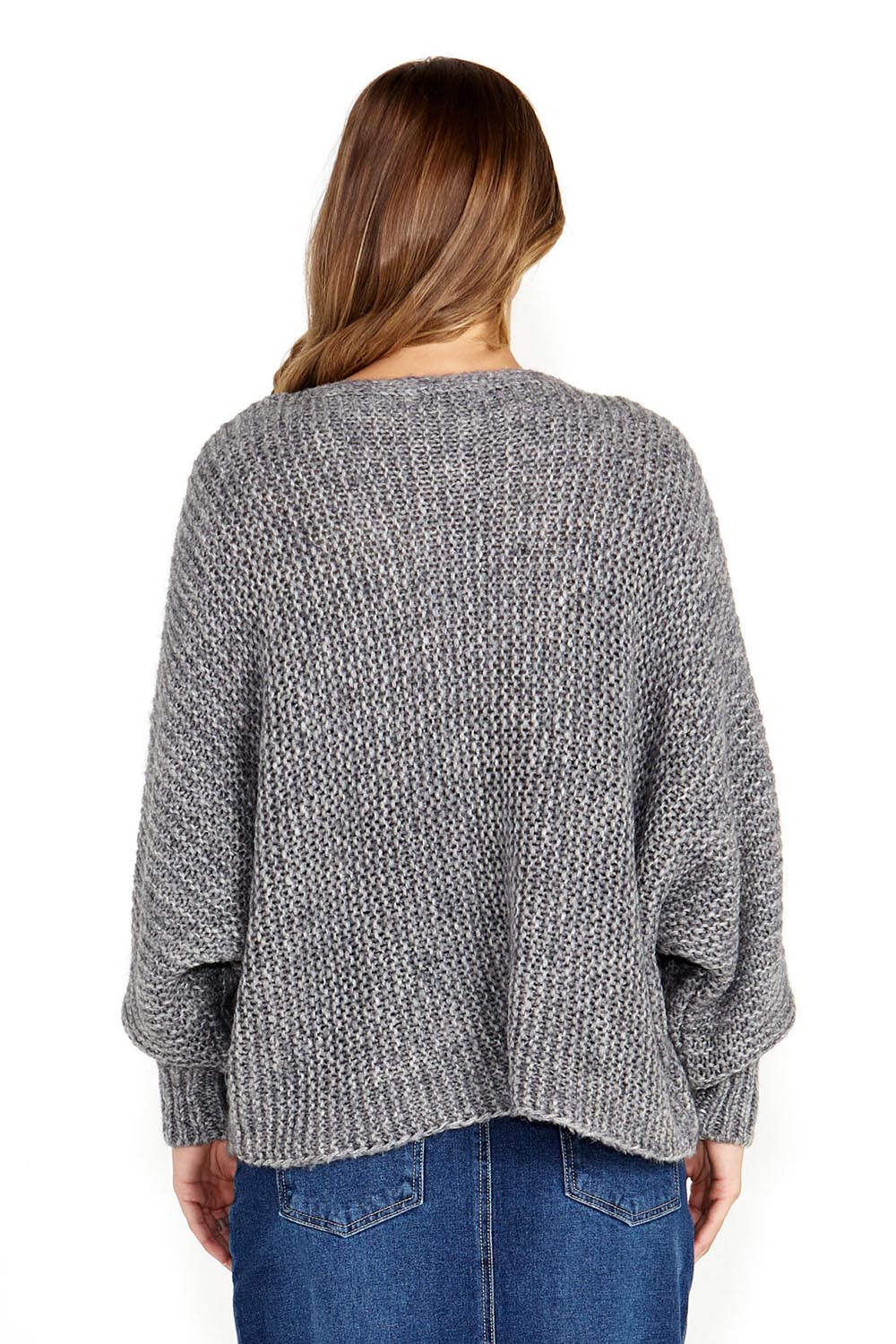 A model wearing the Belinda Chunky Cable Knit in colour Greymarle (Grey), from the back