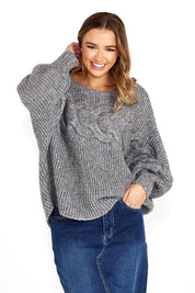 A model wearing the Belinda Chunky Cable Knit in colour Greymarle (Grey), from the front, cropped image