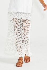 A model wearing the Clover Lace Cotton Skirt in colour White (White), from the front, cropped image