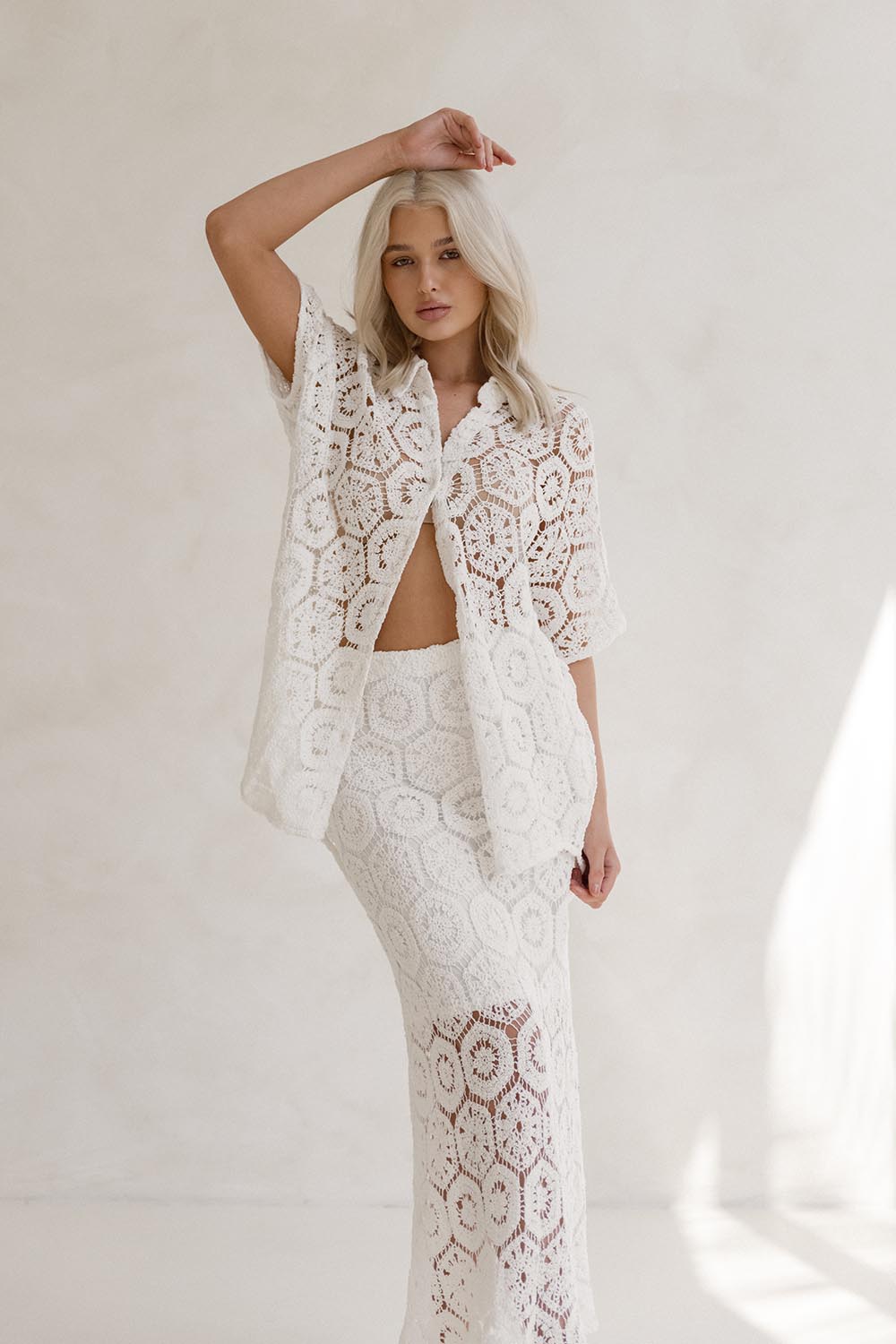 A model wearing the Clover Lace Cotton Skirt in colour White (White), from the front, showing the whole outfit