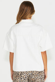 A model wearing the Wyatt Short Sleeve Denim Shirt in colour White (White), from the back