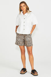 A model wearing the Wyatt Short Sleeve Denim Shirt in colour White (White), from the front, showing the whole outfit