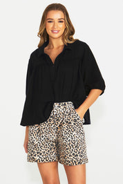 A model wearing the Wyatt Denim Shorts in colour Animal, from the front, cropped image
