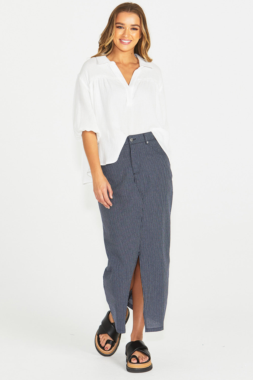 A model wearing the Liberty Cotton Maxi Skirt in colour Navy (Blue), from the front, showing the whole outfit